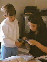 Vintage-style image of Carolyn and Christopher Hallowell captured on VHS, evoking sibling nostalgia and early inspiration behind The Hallowed House.