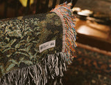 a homepage product image with a close up of a Hallowed House product label