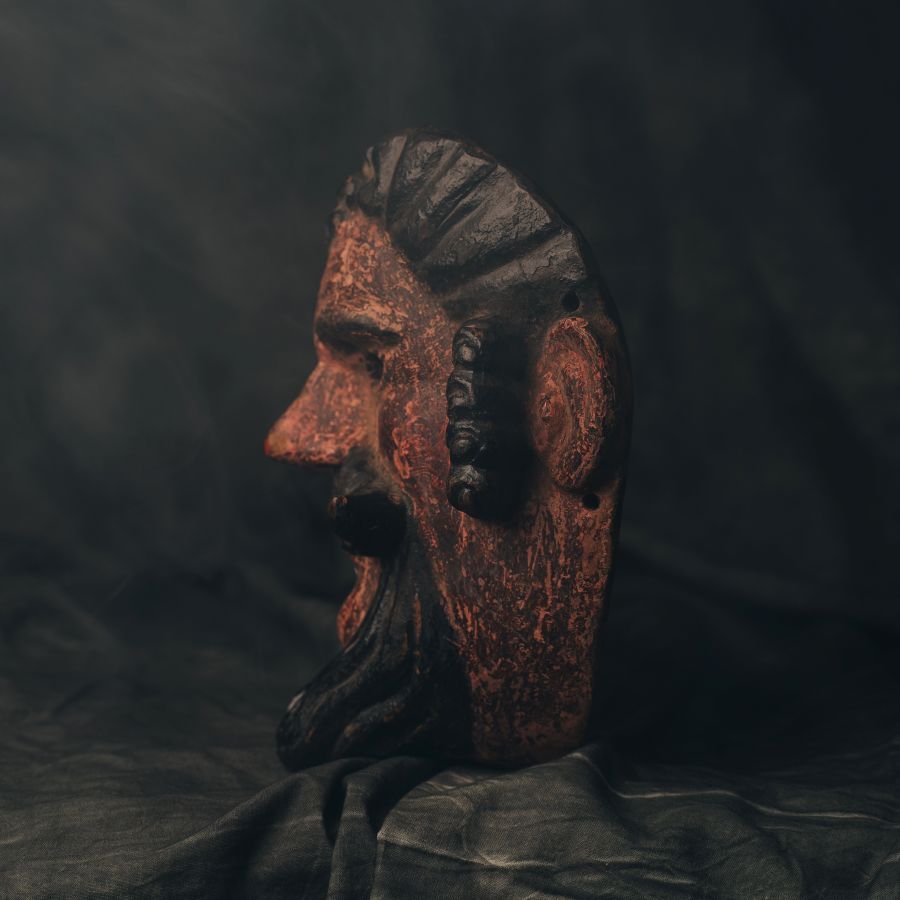 Decorative Guatemalan wood mask with a dark background