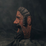 Decorative Guatemalan wood mask with a dark background