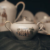 A white Bavarian teapot with decorative design on a dark surface