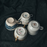 Bottom view of mismatched vintage saucers showing maker’s marks, glaze wear, and signs of their well-traveled past.