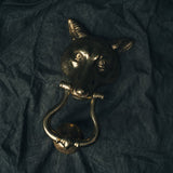 Close-up of the fox door knocker’s facial details and patina, showing texture in the brass and character in the design.