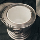 Interior view of the knight’s helmet ice bucket showing the brushed aluminum basin and functional depth.