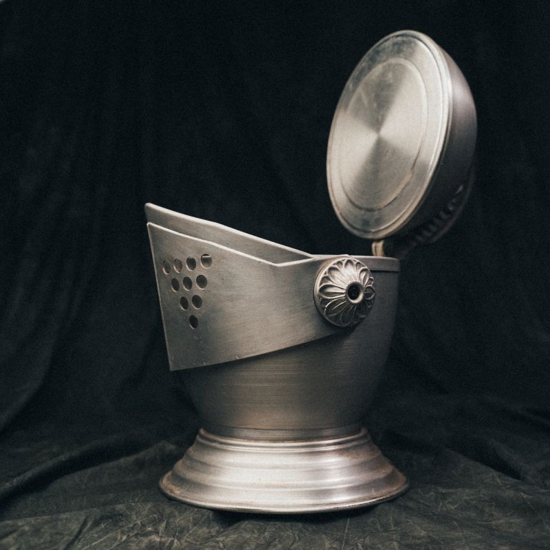 Open view of the knight’s helmet ice bucket with lid lifted to reveal the ice compartment inside.