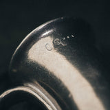 Close-up of the Wilton pewter mug’s spiral handle and printed insert, highlighting craftsmanship and vintage detail.