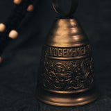 Close-up of the engraved text on the early 20th century Gothic brass monastery bell, highlighting its aged lettering and historical craftsmanship.