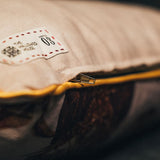 Close-up of the Elixir of Life pillow’s bottom zipper with gold piping, highlighting its refined finish and hidden closure.