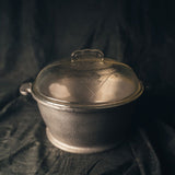 Guardian Aluminum Four Quart Dome Cooker with glass lid on a dark background