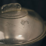 Close-up of the Guardian Aluminum Four Quart Dome Cooker with engraved symbols on the glass lid 