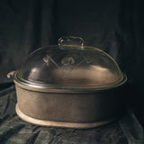 Guardian Service Cast Aluminum Roaster with glass lid on a dark background