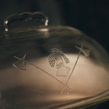 Close-up of the Guardian Service Cast Aluminum Roaster with engraved symbols on the glass lid 