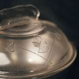 Close-up of One Quart Dome Cooker with engraved designs on a dark background