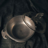 Decorative aluminum dome cooker with a lid on a dark background