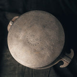 Close-up of a Guardian Service One Quart Dome Cooker with 'Guardian Service' engraved on the bottom