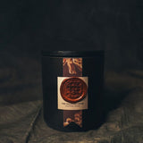 Homepage product shot of The Elixir of Life candle with an botanicals on the label