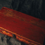 Vintage red hand painted wooden box with a dark background
