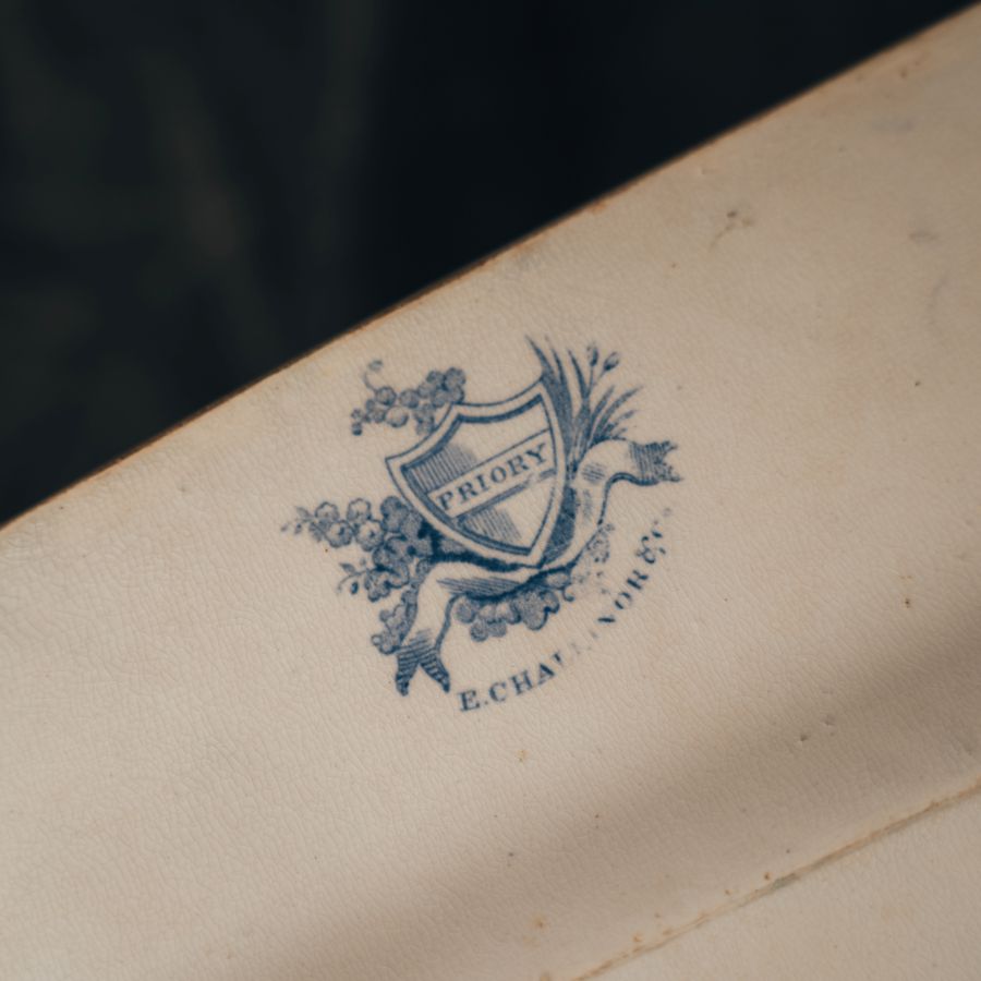 Priory branding with a blue crest and text on the bottom of the Priory E Challinor & Co. serving platter