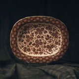 Decorative rectangular ceramic platter with floral patterns on a dark background