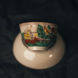 Ceramic cup with scenic design on a dark background