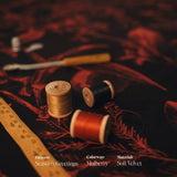 Spools of thread and a ruler on the Seasons Greetings mulberry velvet fabric with 'Season's Greetings' text overlay.