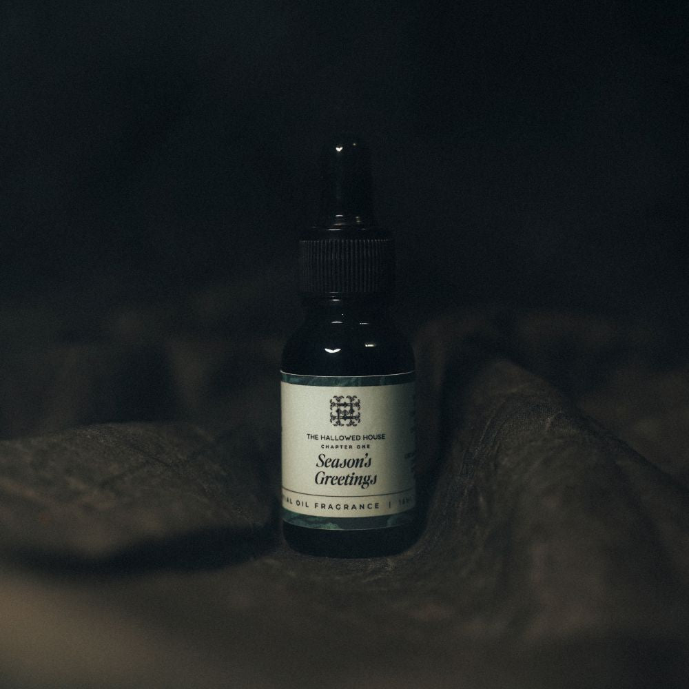Season's Greetings essential oil with holiday greenery and nostalgic warmth.