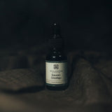 Season's Greetings essential oil with holiday greenery and nostalgic warmth.