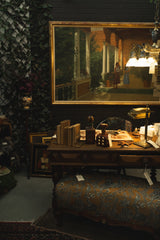 curated desk scene with layered vintage and antique finds 