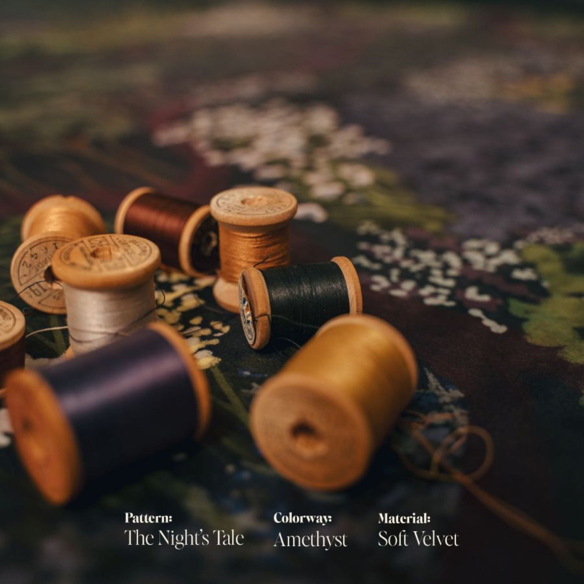 Spools of thread on a textured fabric background with text indicating pattern, colorway, and material.