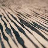 Close-up of the textured The Night's Tale Ink Veil fabric with white and and black design.