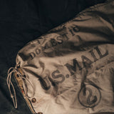 Vintage-style bag with 'U.S. Mail' text on a dark background