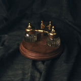 Vintage Wood and Brass Dual Inkwell Stand on a dark fabric background