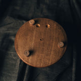 A shot of the bottom of the wooden base of the Brass and Glass Dual Inkwell Stand