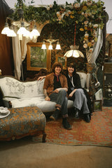 Image of Brother and Sister behind Hallowed house sitting in a pop-up display